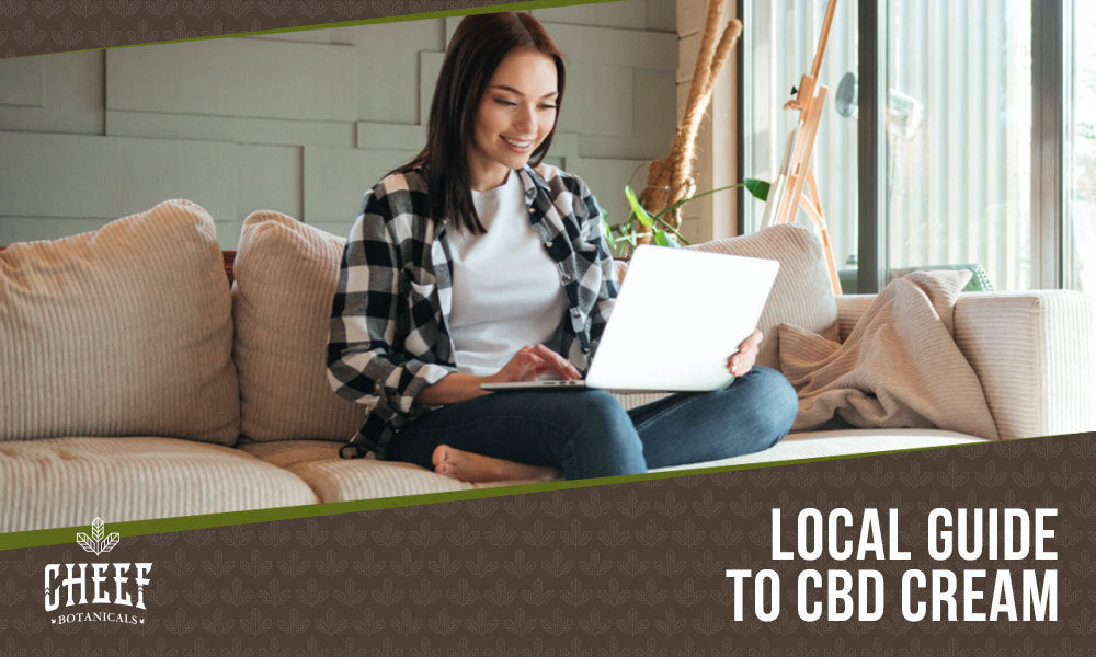 Featured blog image by Cheef Botanicals showing a woman using a laptop on a couch with the text “Local Guide to CBD Cream,” highlighting CBD cream.