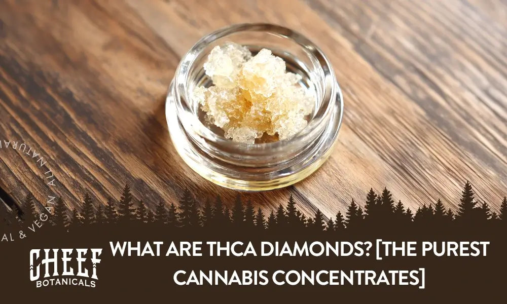 A glass container with THCa diamonds inside sitting on a wooden table.
